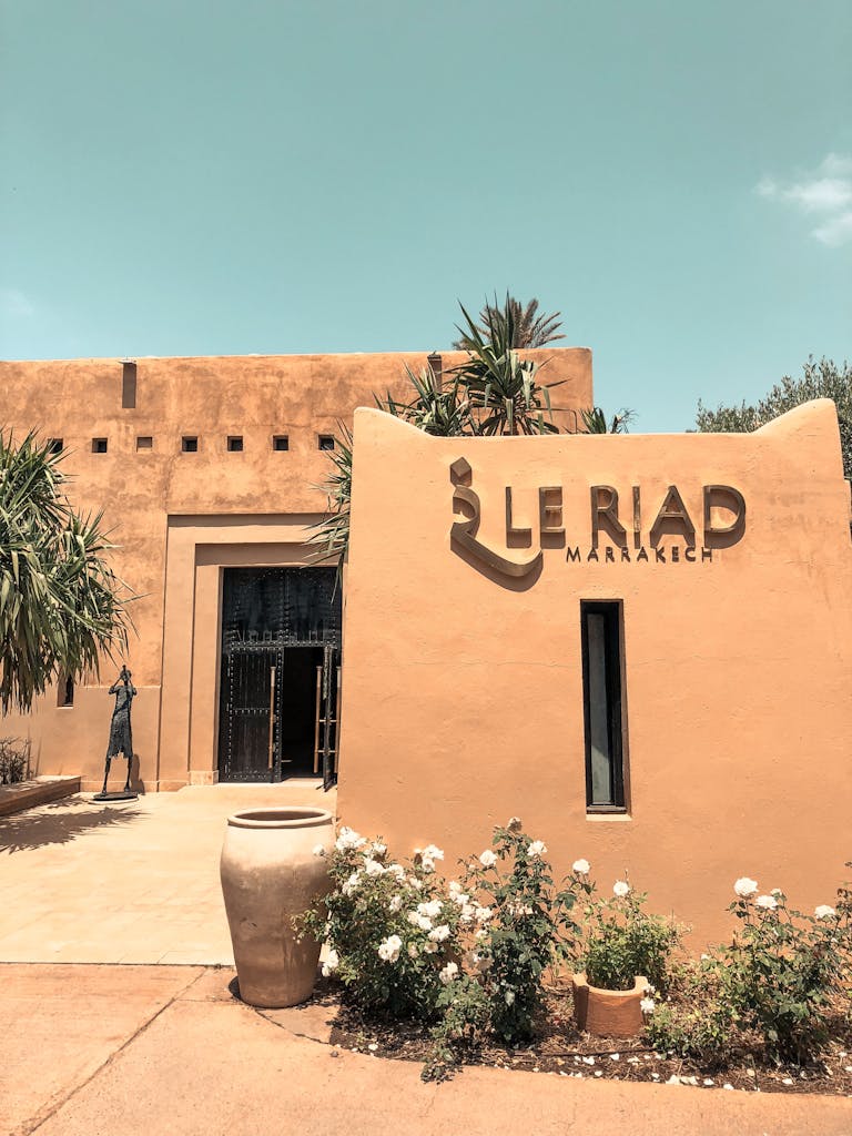 Explore the stunning architecture of Le Riad in Marrakech, Morocco, surrounded by desert-inspired landscape.